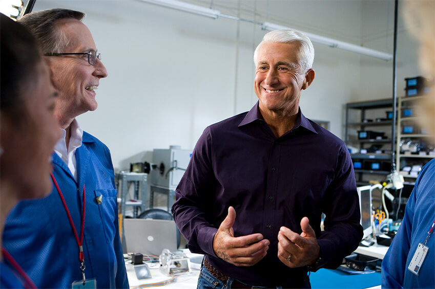 Dave Reichert talking with someone in an office