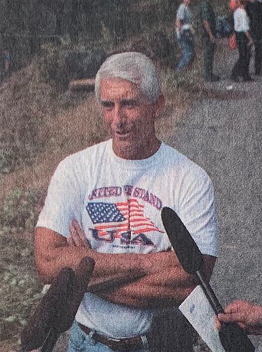 Dave Reichert talking to the press out in the field